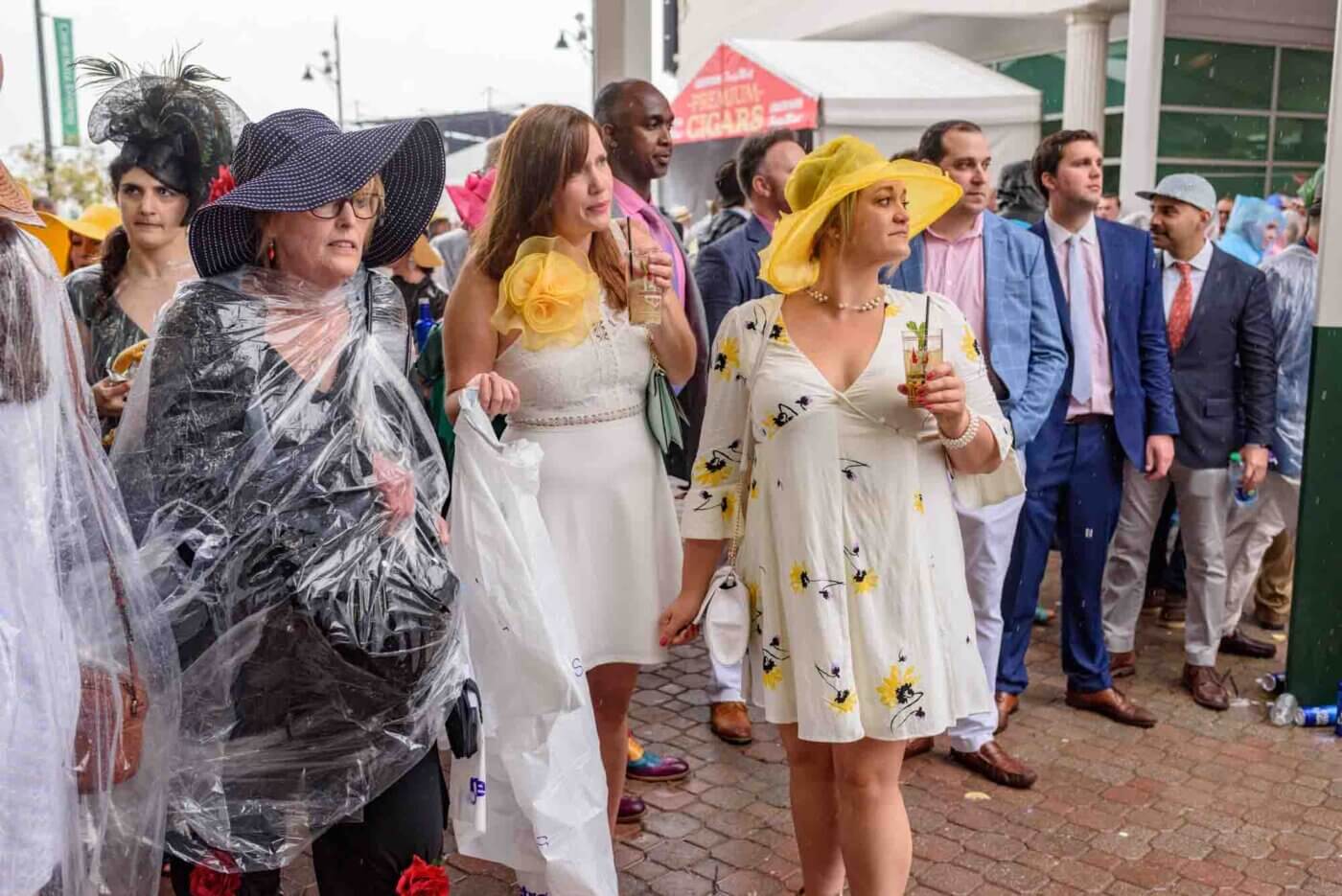 Soggy racing fans take shelter from the rain to make bets on the running of the 144th Kentucky Derby. May 5, 2018