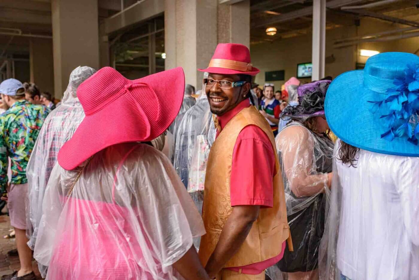 Soggy racing fans take shelter from the rain to make bets on the running of the 144th Kentucky Derby. May 5, 2018
