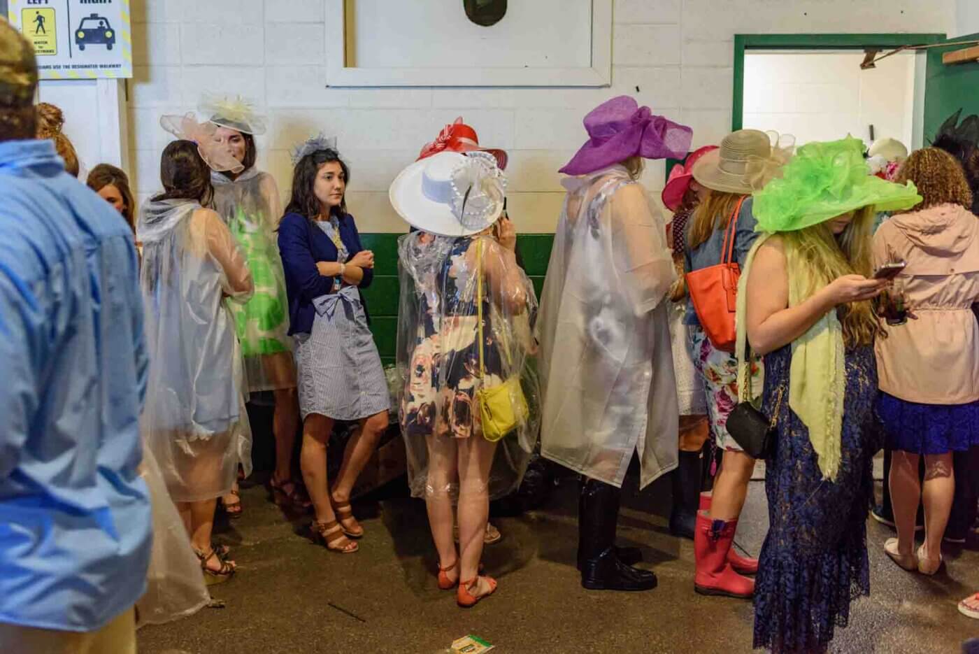 Soggy racing fans take shelter from the rain to make bets on the running of the 144th Kentucky Derby. May 5, 2018