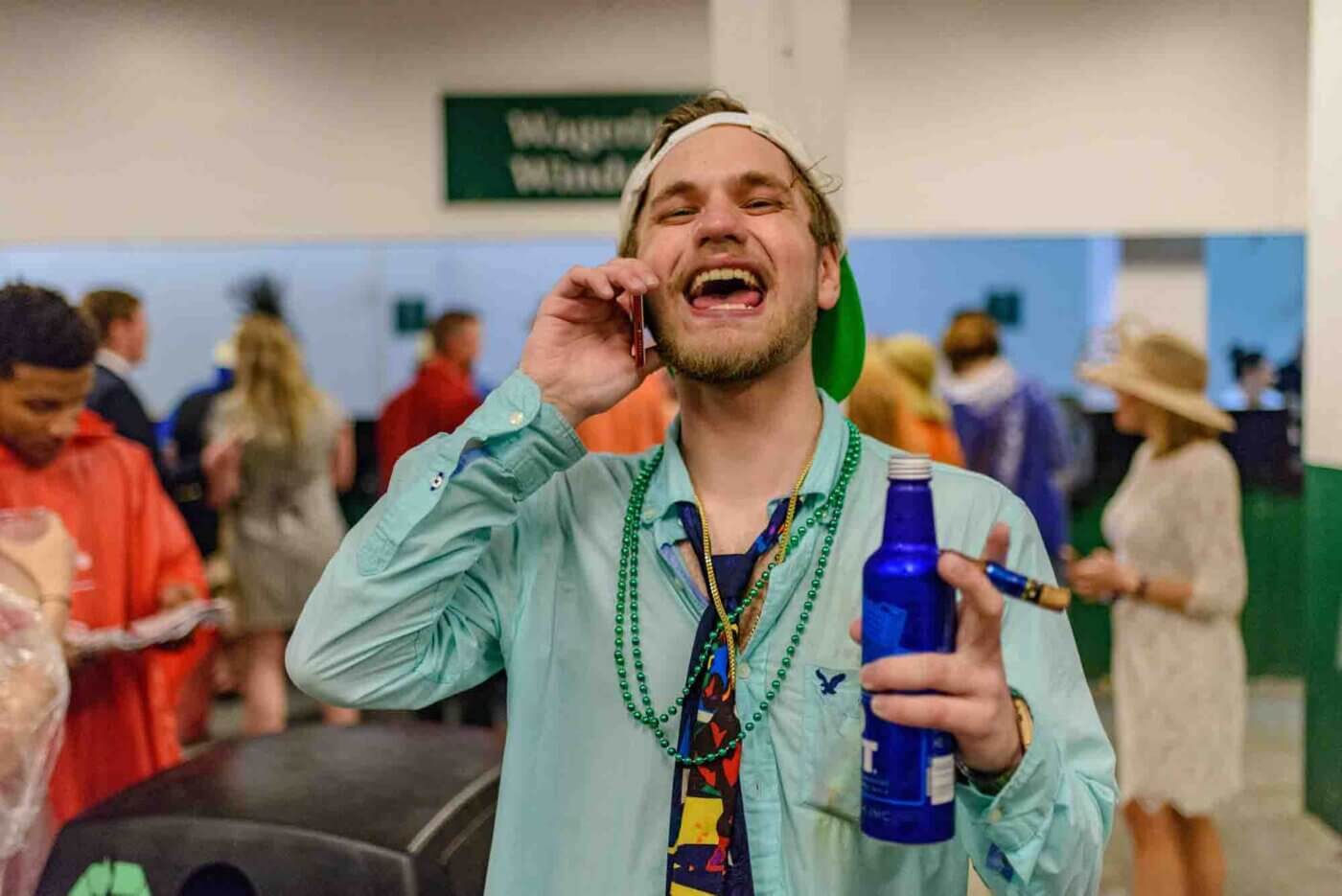 Soggy racing fans take shelter from the rain to make bets on the running of the 144th Kentucky Derby. May 5, 2018
