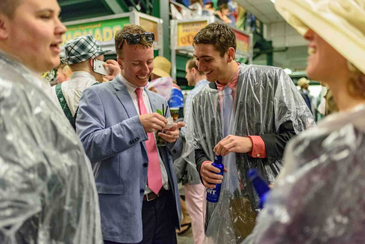 Soggy racing fans take shelter from the rain to make bets on the running of the 144th Kentucky Derby. May 5, 2018