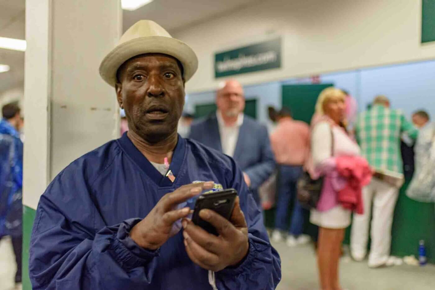 Soggy racing fans take shelter from the rain to make bets on the running of the 144th Kentucky Derby. May 5, 2018