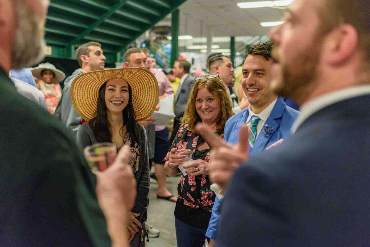 Soggy racing fans take shelter from the rain to make bets on the running of the 144th Kentucky Derby. May 5, 2018