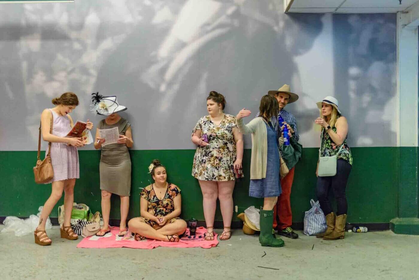 Soggy racing fans take shelter from the rain to make bets on the running of the 144th Kentucky Derby. May 5, 2018