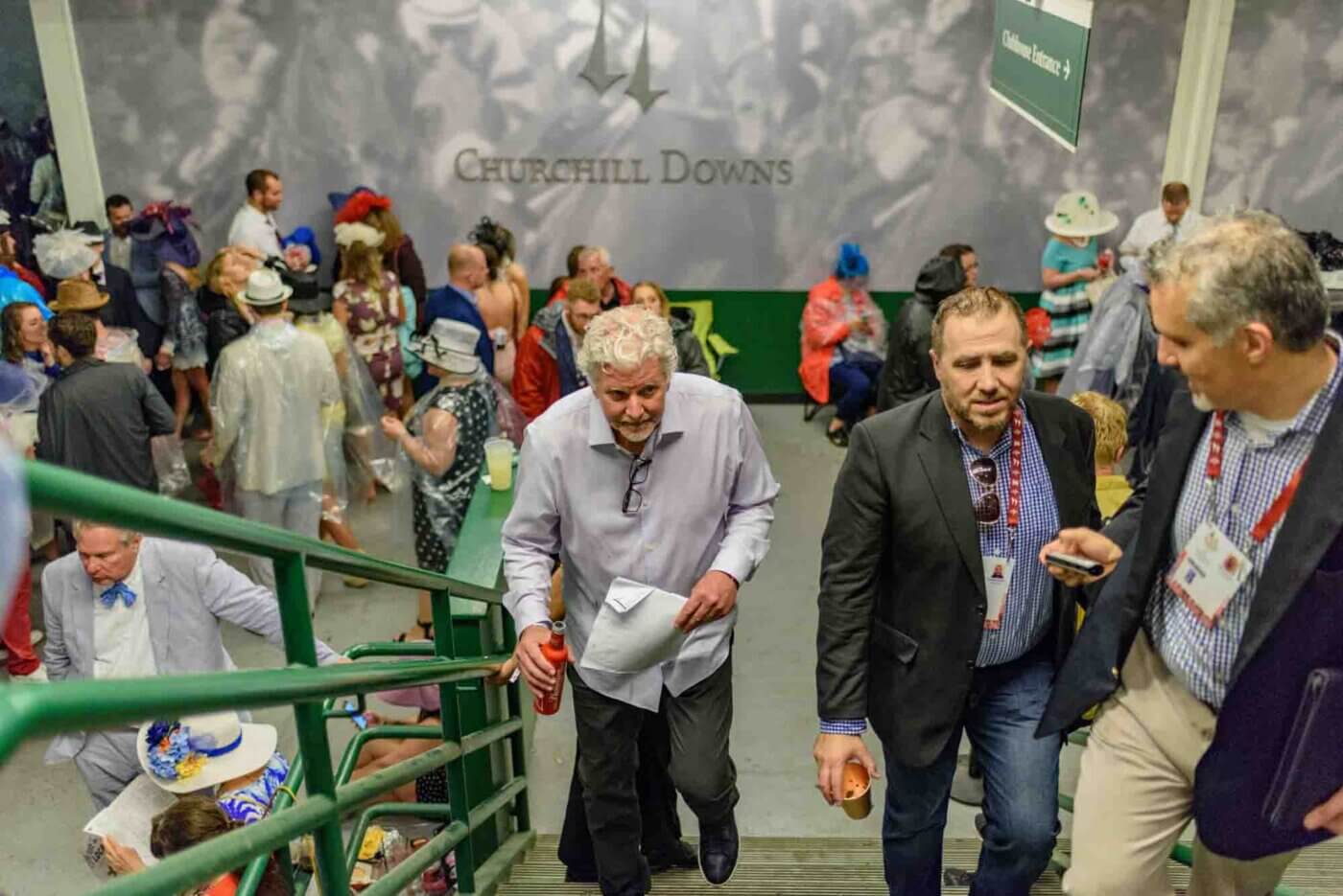 Soggy racing fans take shelter from the rain to make bets on the running of the 144th Kentucky Derby. May 5, 2018