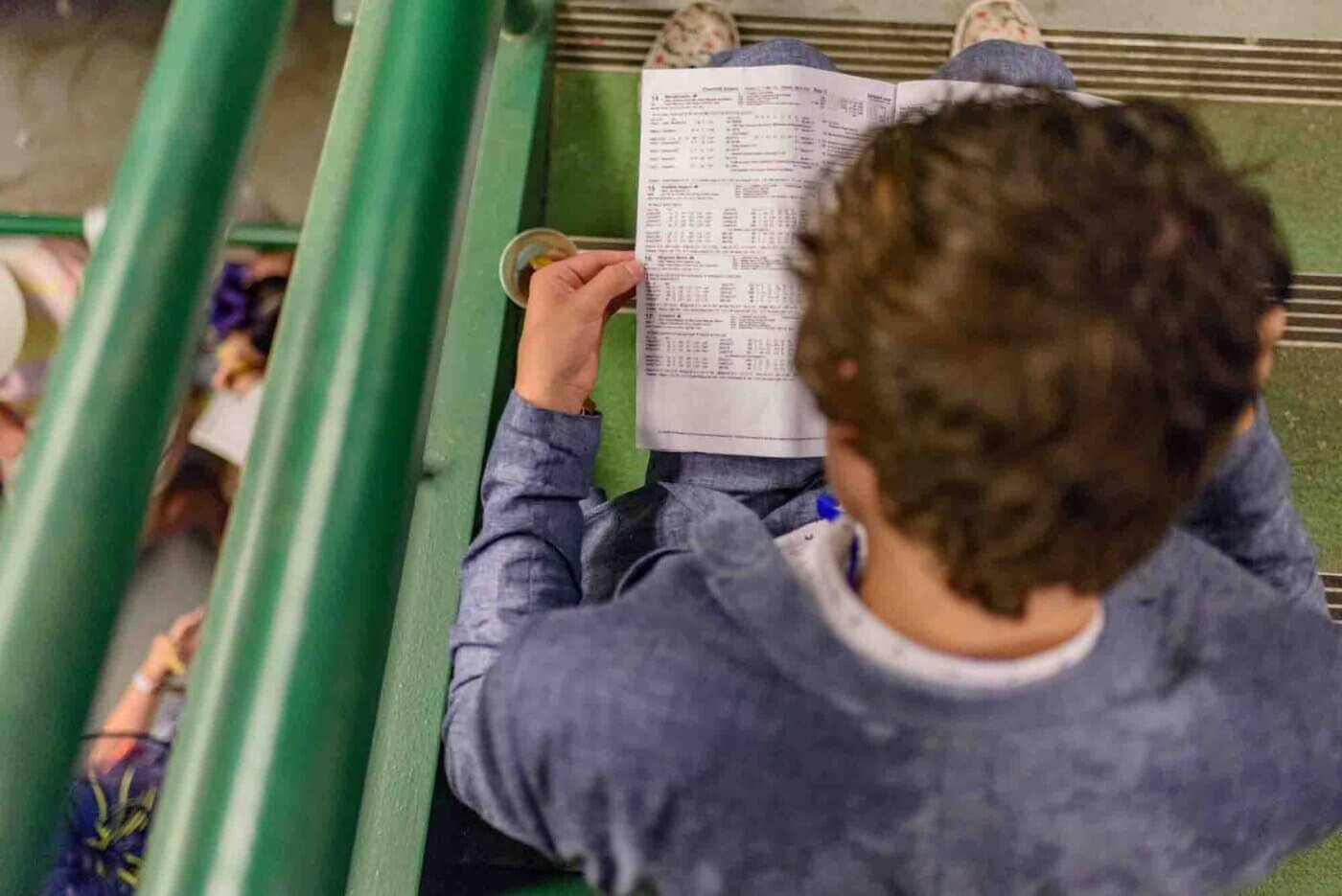 Soggy racing fans take shelter from the rain to make bets on the running of the 144th Kentucky Derby. May 5, 2018
