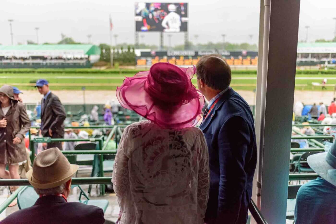 Soggy racing fans take shelter from the rain to make bets on the running of the 144th Kentucky Derby. May 5, 2018