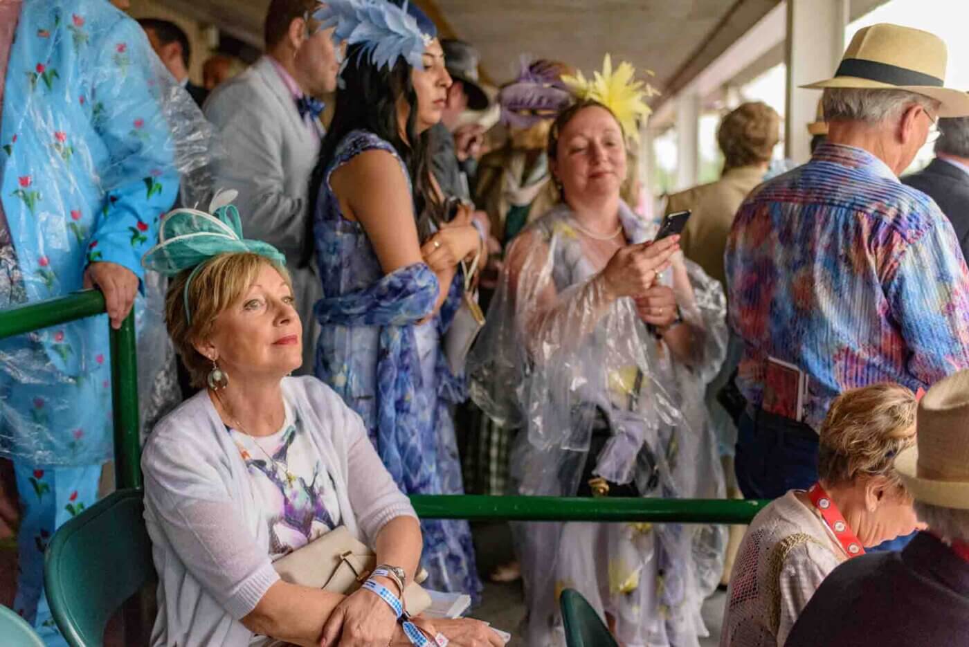 Soggy racing fans take shelter from the rain to make bets on the running of the 144th Kentucky Derby. May 5, 2018