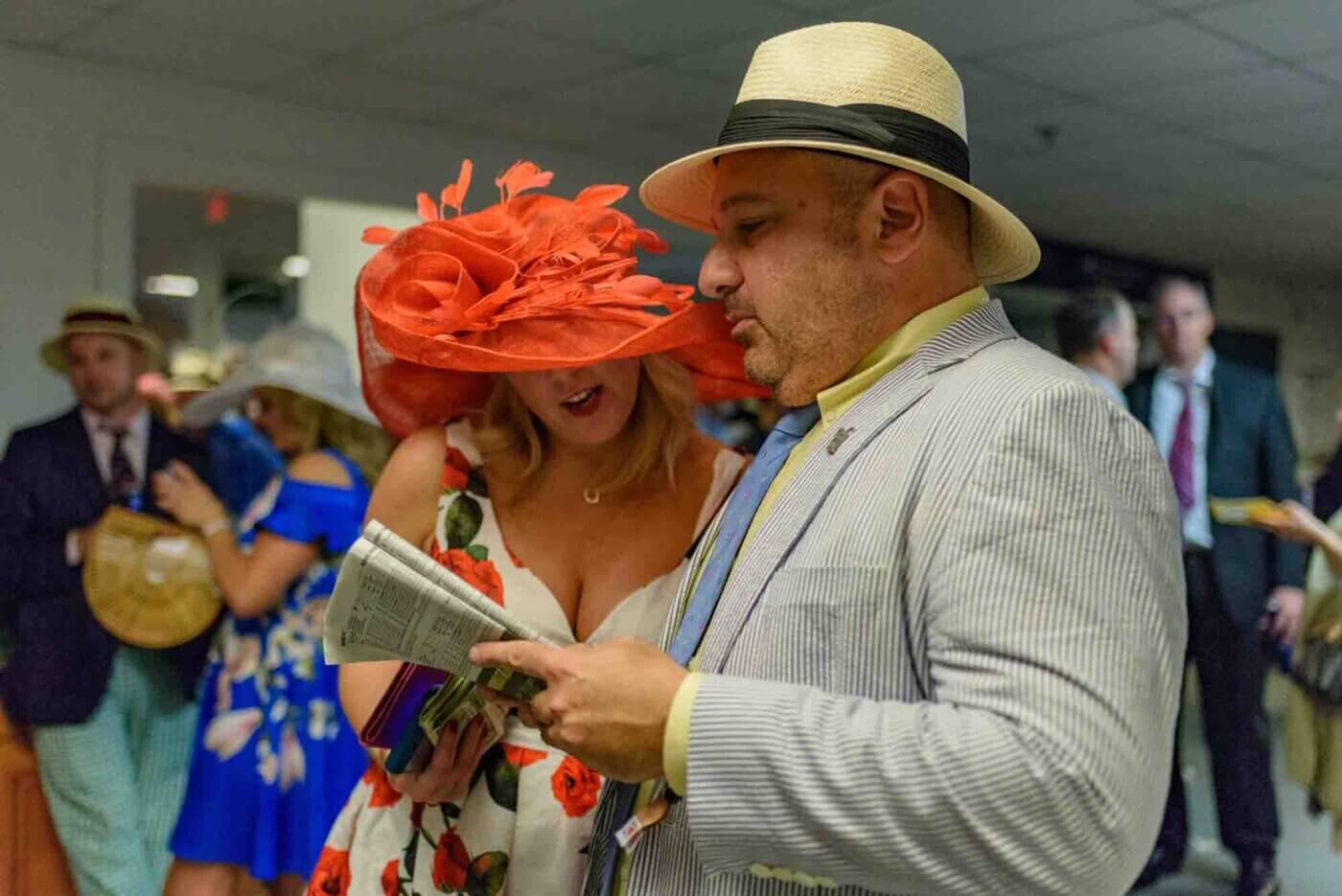 Soggy racing fans take shelter from the rain to make bets on the running of the 144th Kentucky Derby. May 5, 2018