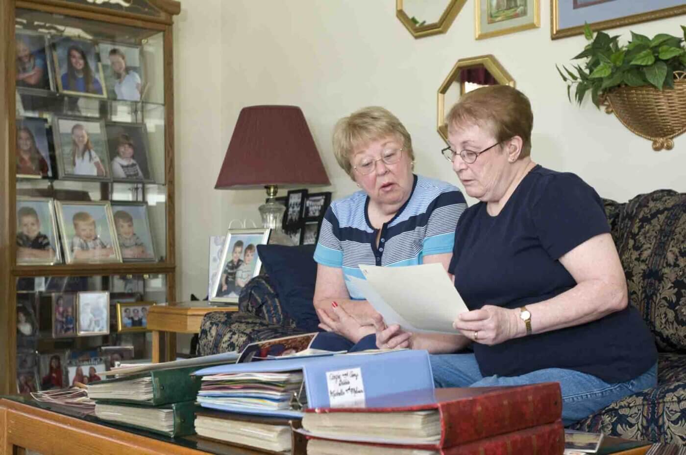 For Louisville Magazine: Fraternal twins Janice Mingus, left, and Judy Ernst look through photos of their twins through the years as participants in a UL twin study Friday, June 21, 2012 in Louisville, Ky.