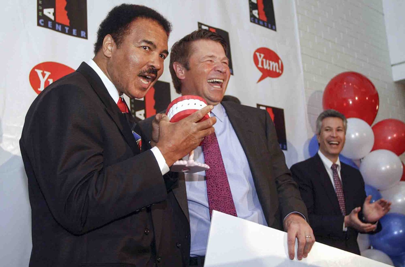 Boxing legend Muhammad Ali receives the Yum! Award from Yum! Brands chairman and CEO David Novak, Wednesday, March 26, 2003, in Louisville, Ky., as Yum! announces a $500,000 donation to the Muhammad Ali Center, scheduled to open in 2004.
